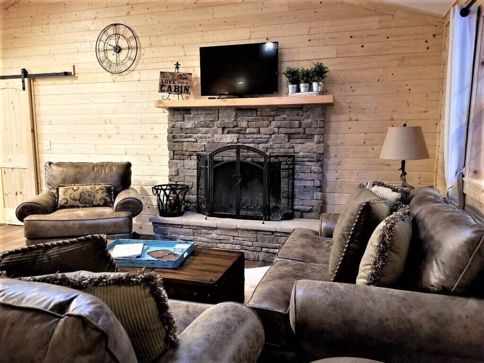 Wood burning fireplace and Roku TV.  Books and games in coffee table.
