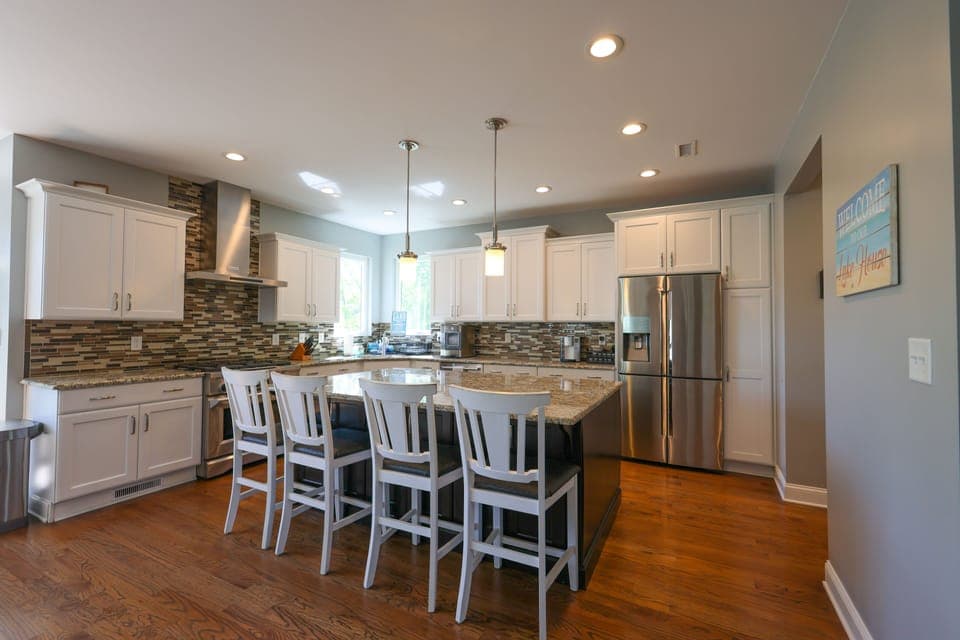 Kitchen with large island, 6 burner gas stove, microwave, and 4 door frig.  