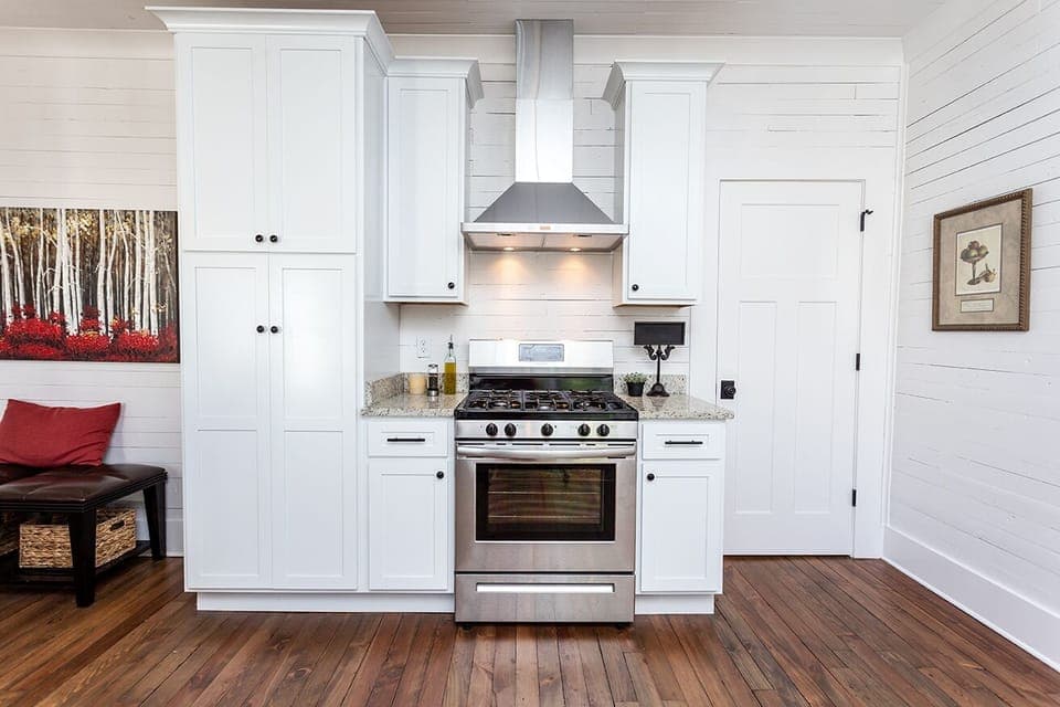 Pantry with small appliances, plenty of dishes, glasses, pots, and pans. 
