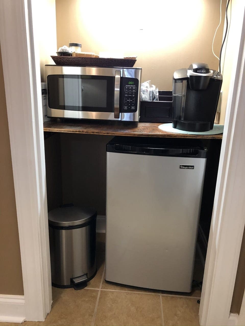 Kitchenette with microwave, coffee maker, refrigerator.