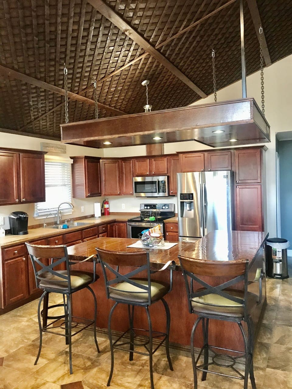 Kitchen with  cherry cabinets. 3 chair bar area. Updated appliances with Keuirg