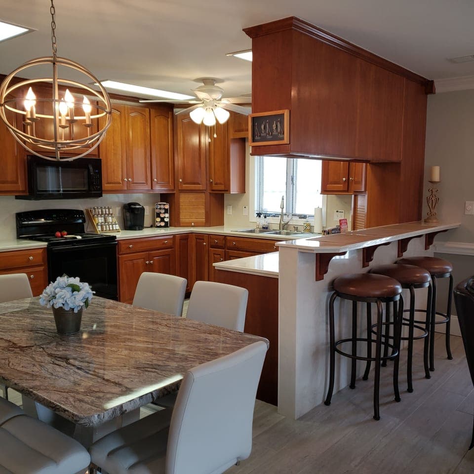 Dining for 6 plus 3 barstools at bar-height kitchen counter.