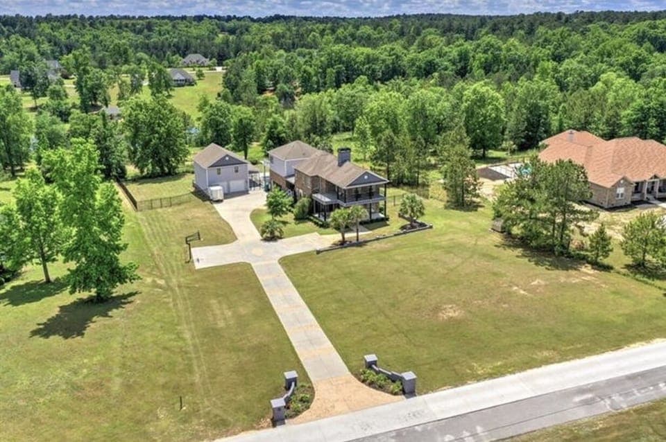 Aerial Front. Basketball goal on left middle driveway. 