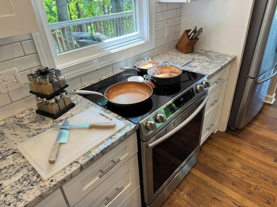 Chef kitchen with cutting boards, selection of knives and chef cooking pans.