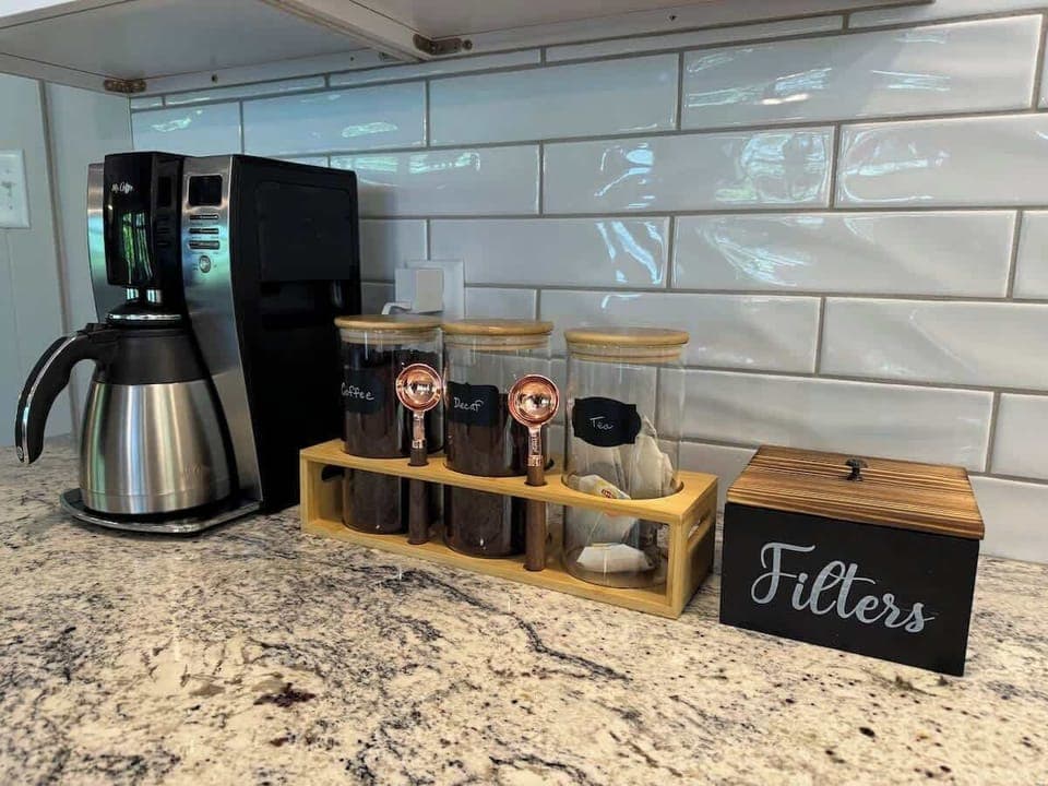 Enjoy our coffee and tea bar. We provide premium coffee both regular and decaf, and also tea if you are not a coffee drinker. Notice the filters next to the coffee for your use.