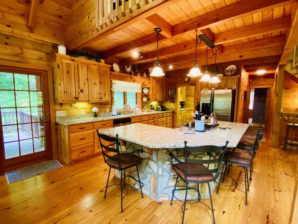 Kitchen with large island including 4 stools 