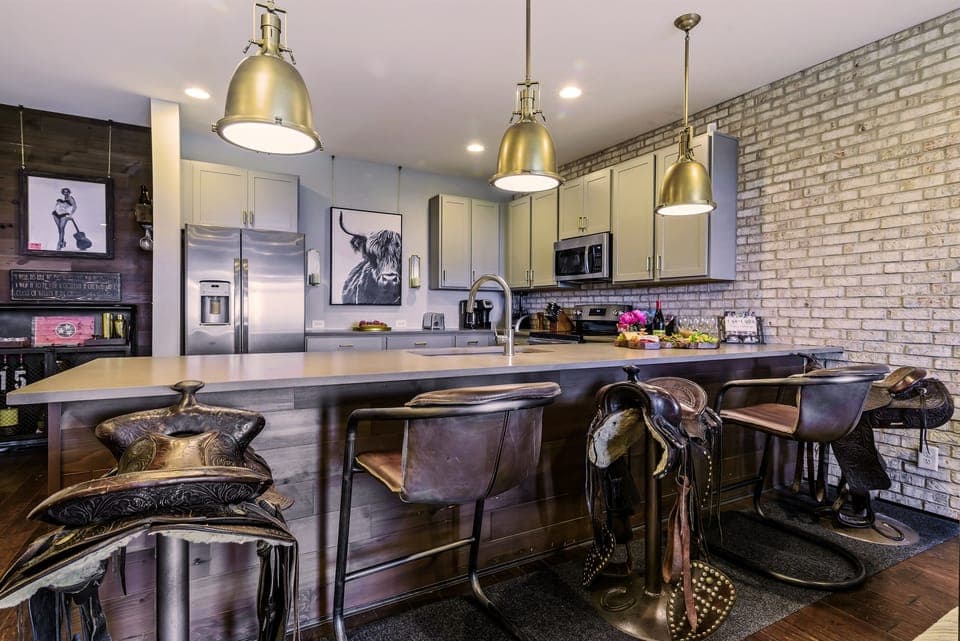 Pull Up a Genuine Horse Saddle Bar Stool, or Relax in a Rustic and Iron Scoop Seat Option.  Bar Seating for 5 Offered at our counter. In LOVE with this Bar Seating!
