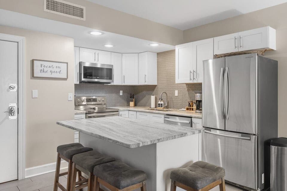 Fully equipped kitchen for all of your cooking needs! Regular drip coffee machine and coffee provided! Seating available at the island. The kitchen opens up to the living room, great for entertaining!