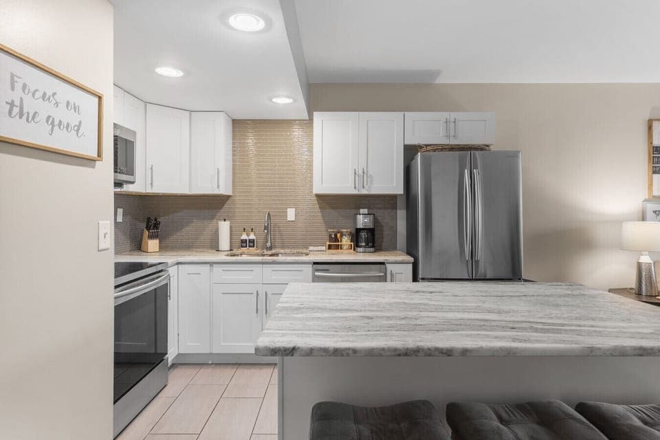 Fully equipped kitchen for all of your cooking needs! Regular drip coffee machine and coffee provided! Seating available at the island. The kitchen opens up to the living room, great for entertaining!