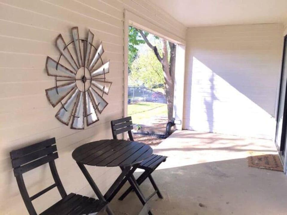 The back patio has a conversation table and chairs. 