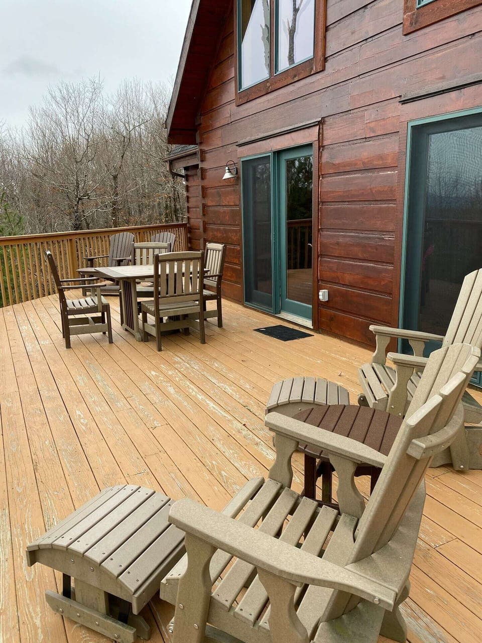 Expansive deck has plenty of comfortable seating, table, and grill.