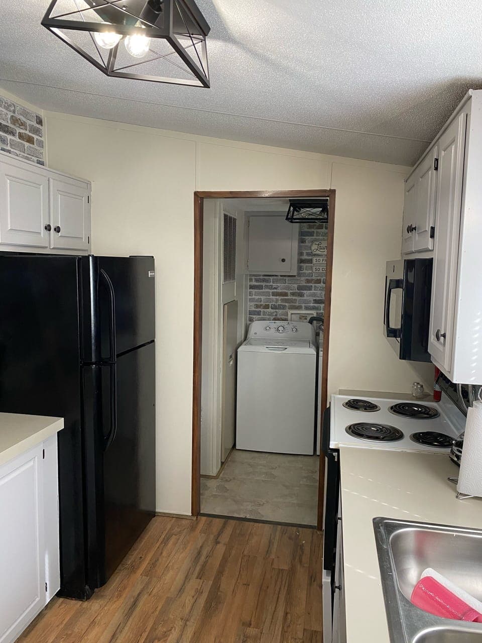 Kitchen and laundry room with full size washer and dryer 