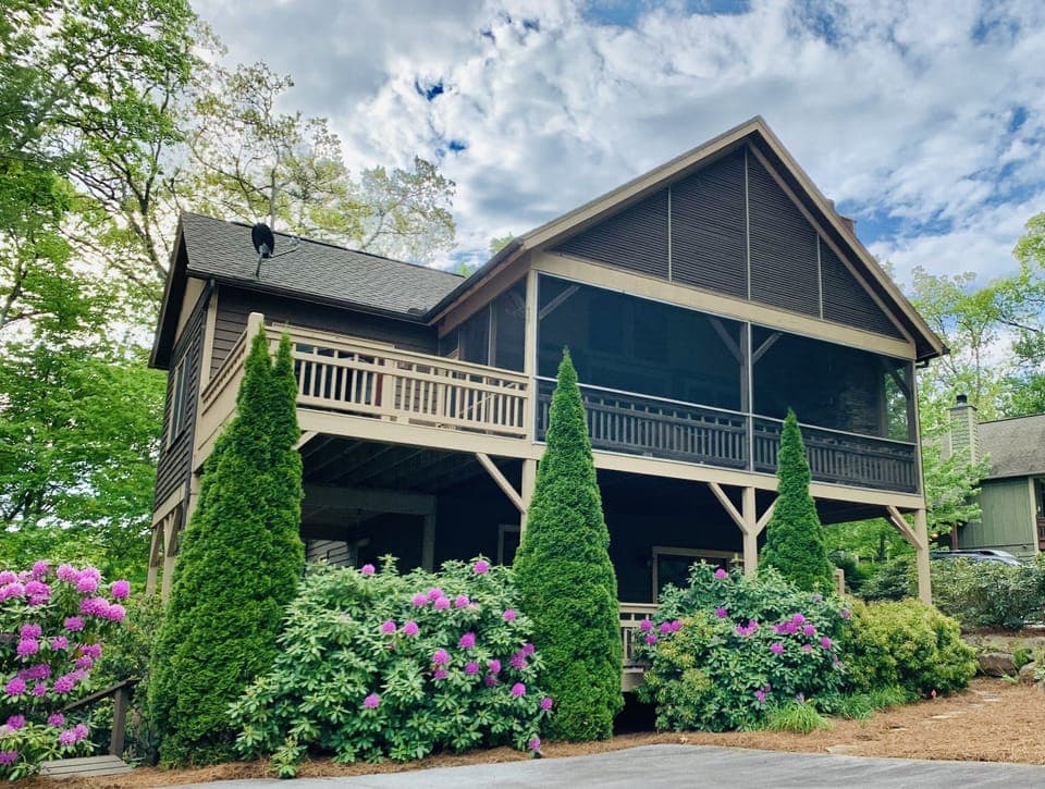 Large screened porch overlooks beautiful landscape in Cashiers.