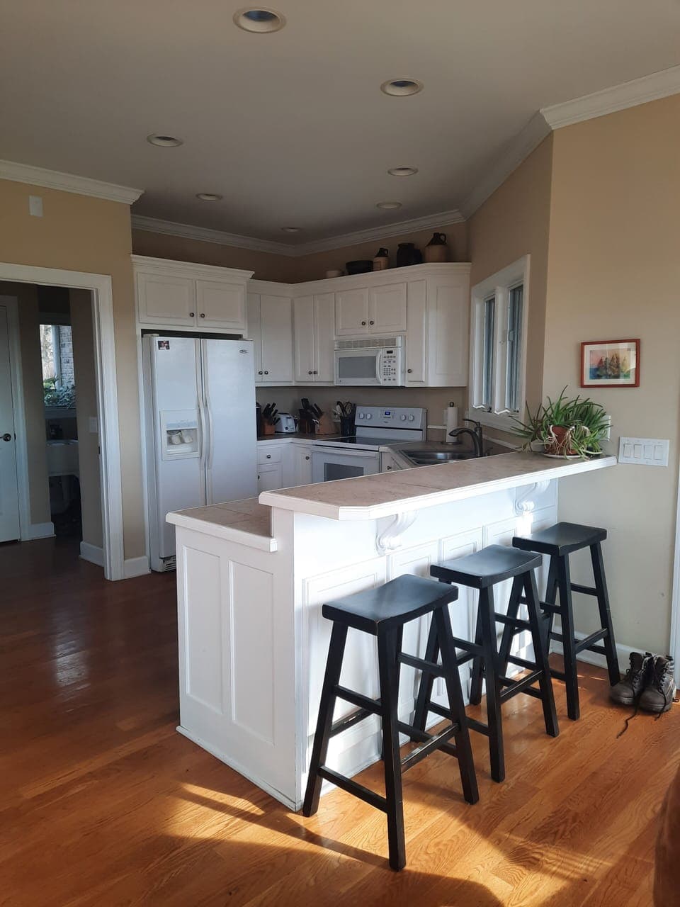 Kitchen area with bar seating for 4 people. 