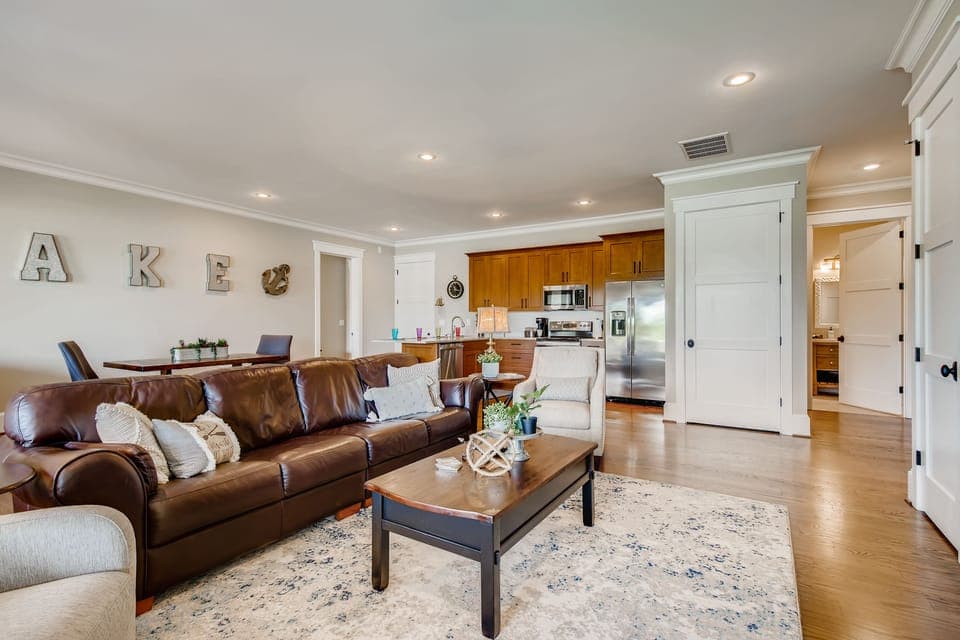 Living room with leather sofa and backyard access.
