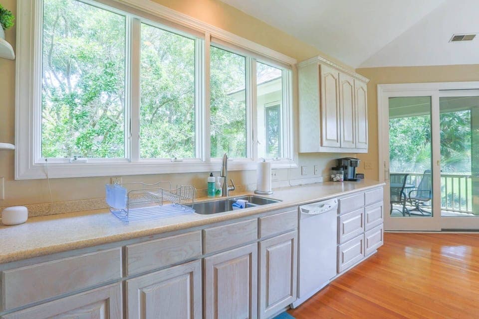 The spacious home receives terrific natural light through its many windows and sliding glass doors.