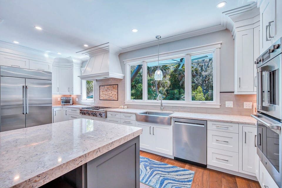 Fully stocked kitchen with stainless steel appliances.