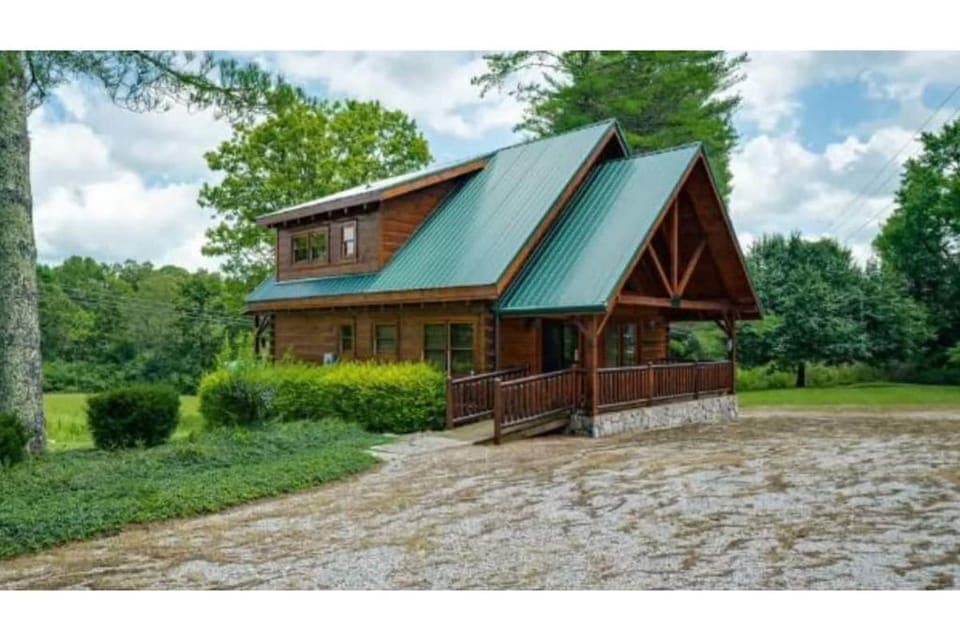 Front of house with large parking area 