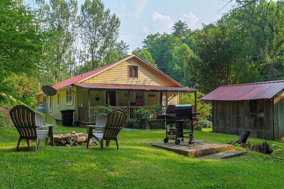 Beautiful backyard with stone fire pit and grilling area