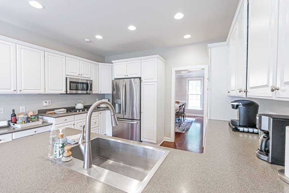 Kitchen wth SS fridge and microwave