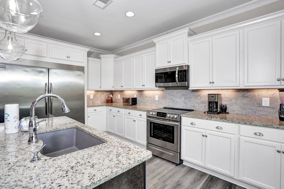 Step into your gourmet kitchen with granite counters, stainless appliances, and crisp white cabinets—perfect for creating memorable meals.