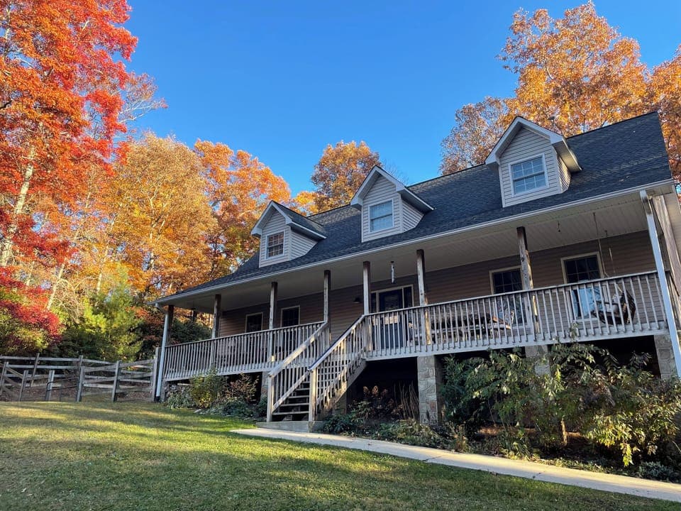 Large covered front porch with fenced side yard.