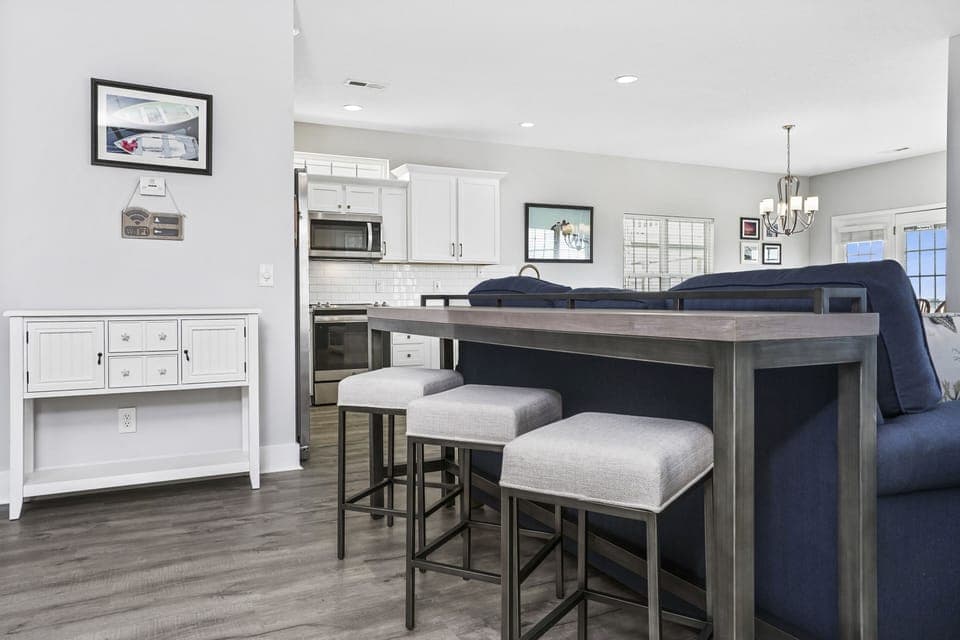 You'll love gathering around this sleek kitchen island with comfortable seating while preparing meals in your fully equipped space.