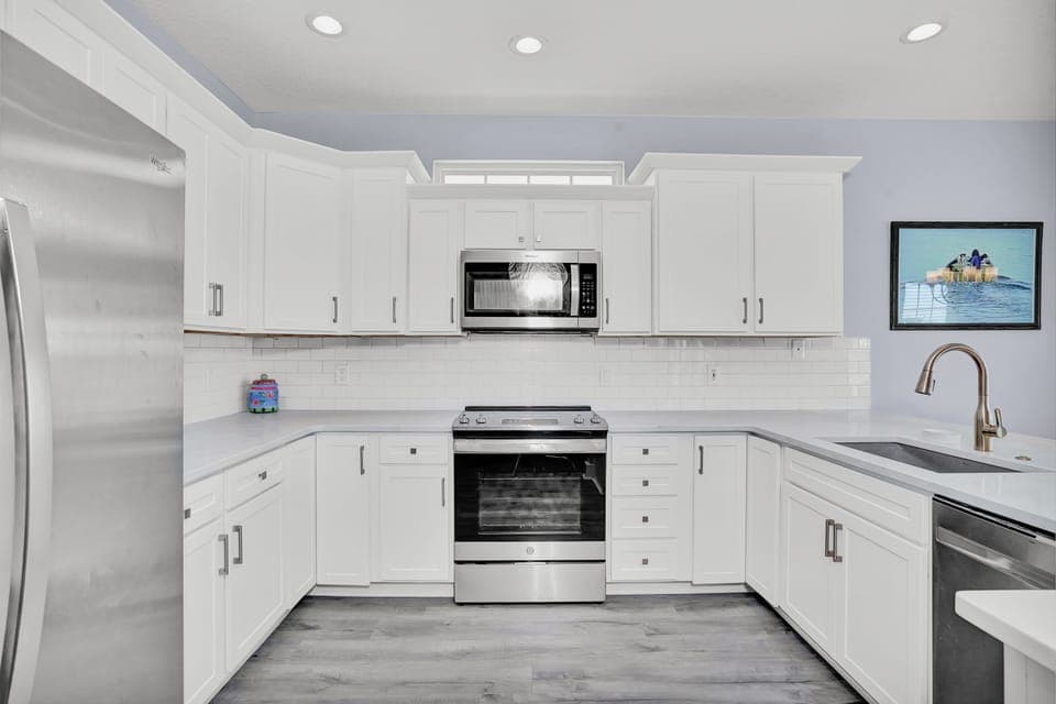 Cook with ease in this bright, fully-equipped kitchen featuring modern appliances and ample counter space for your culinary adventures.