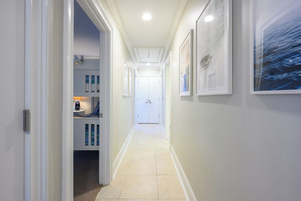 Hallway to twin BR on left and Queen BR further down on the right