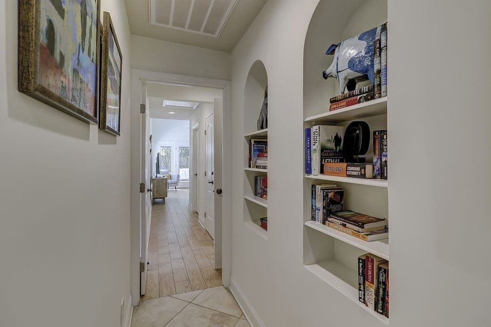 Hallway to primary bedroom. Plenty of reading material.