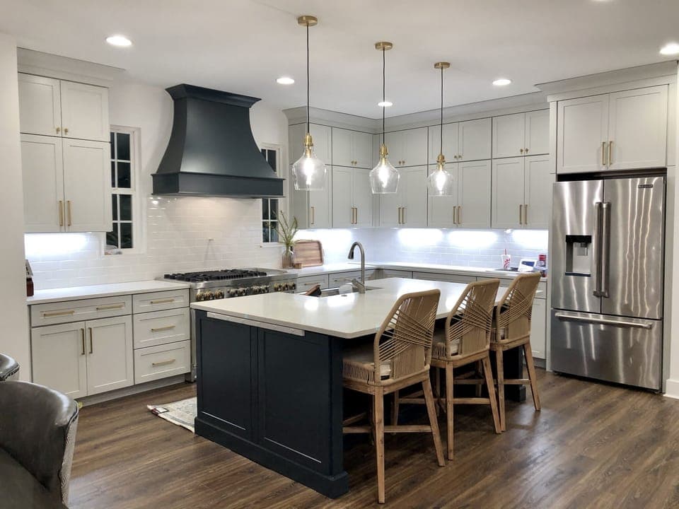 Large island and refrigerator with ice maker. 