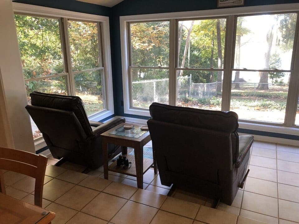Sunroom overlooking backyard and lake 