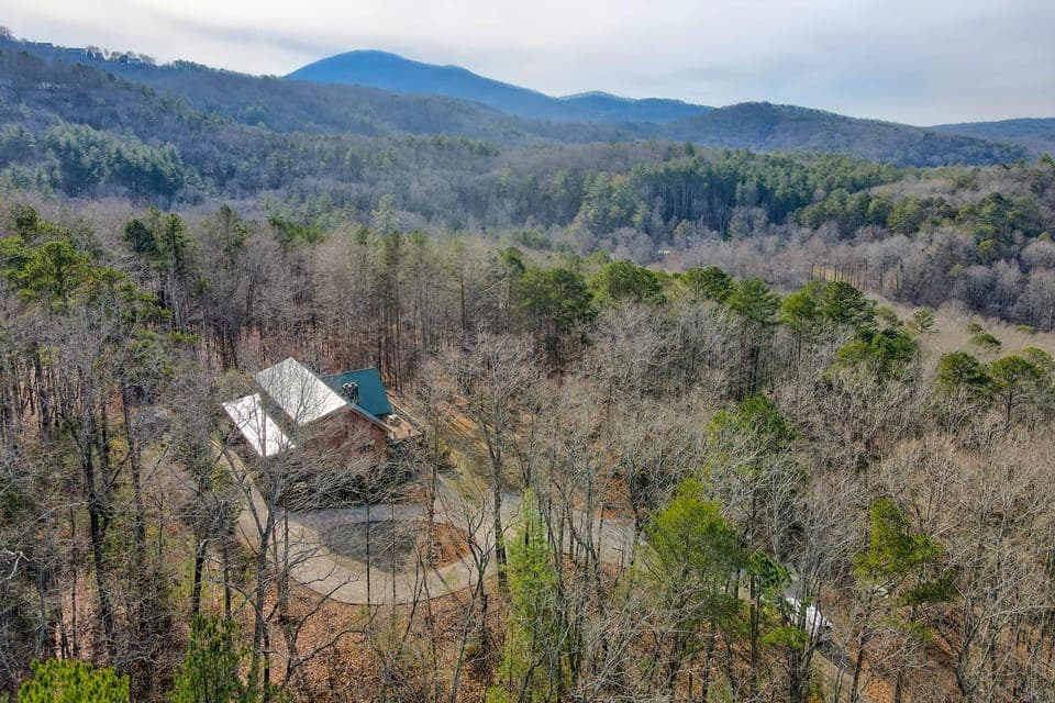 Winter aerial - private mountain lodge, circular drive & parking for 13 vehicles