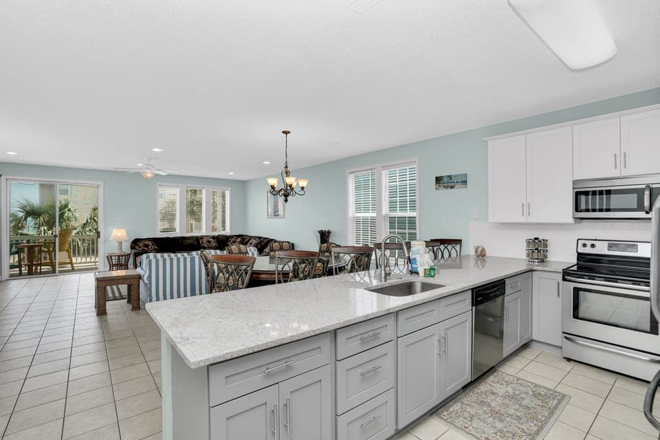 Your fully equipped kitchen flows seamlessly into the living area, perfect for preparing meals while staying connected with family and friends.