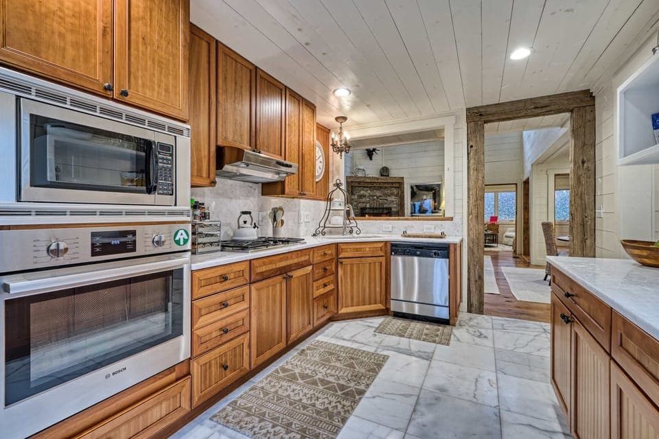 Modern kitchen with stainless steel appliances and warm wood cabinetry