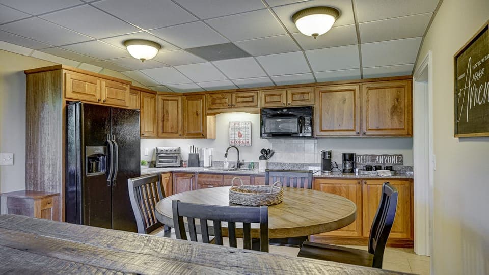 Lower level kitchen with microwave, stove, coffee pot and toaster oven