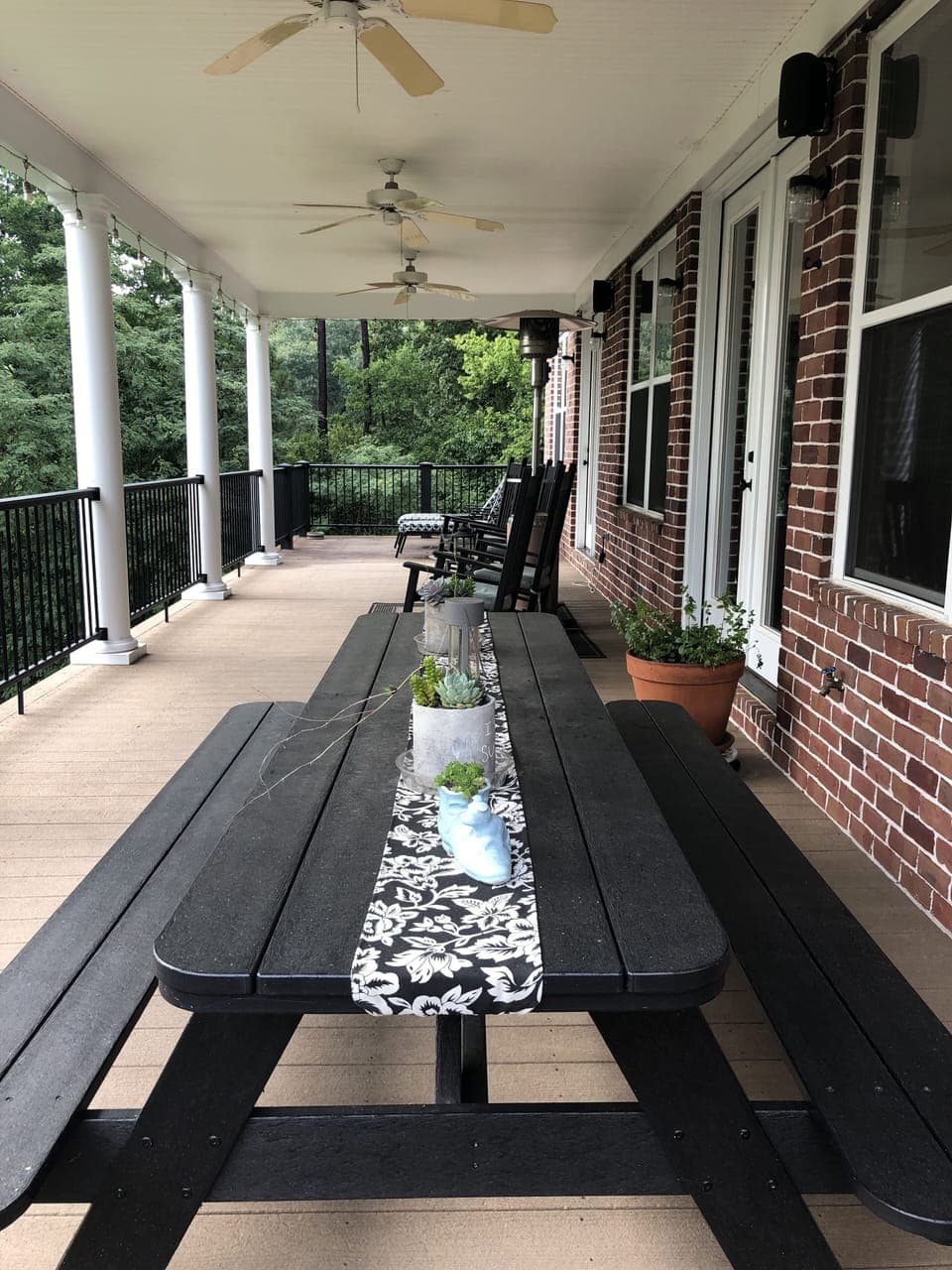Top Deck --- table, rocking chairs and chaise lounges. 