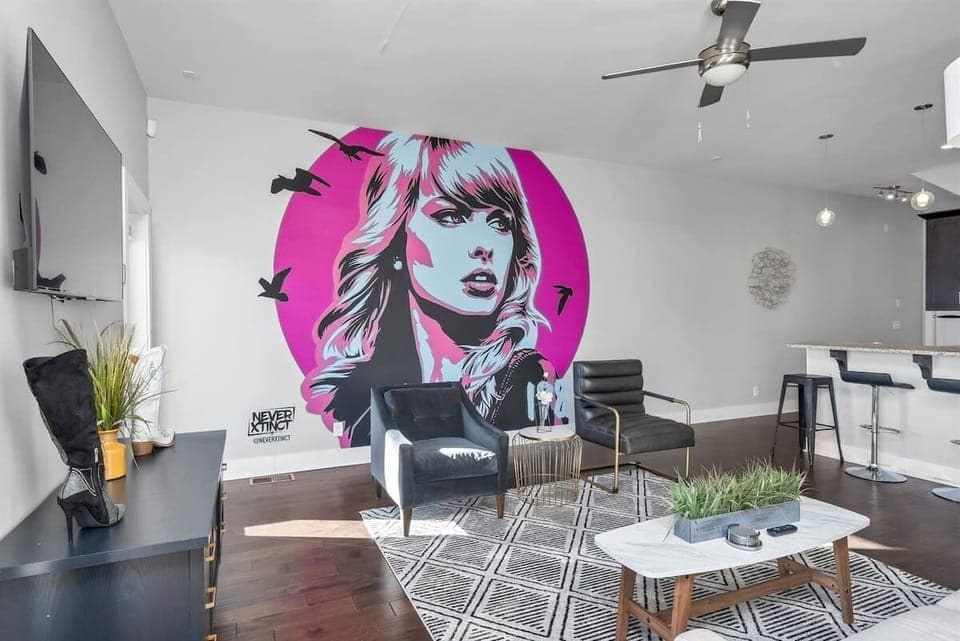 Pop of personality—Taylor Swift artwork brightens the living room.