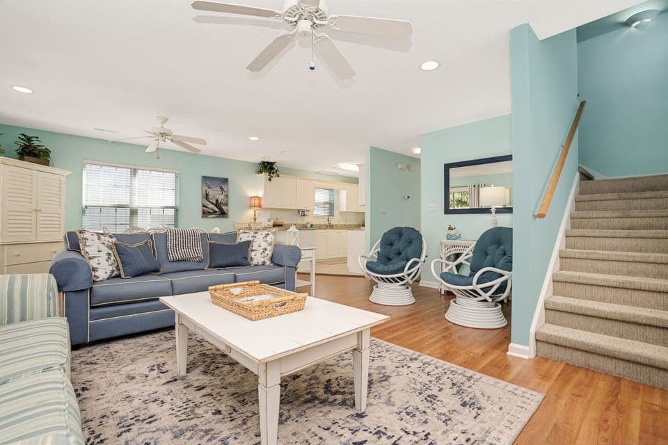Relax in your bright, coastal-inspired living space with comfortable seating and an open layout connecting to your kitchen.
