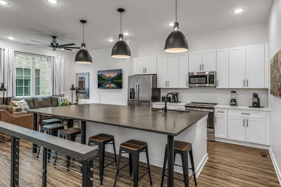 Open-concept floor with large kitchen island for cooking and dining.