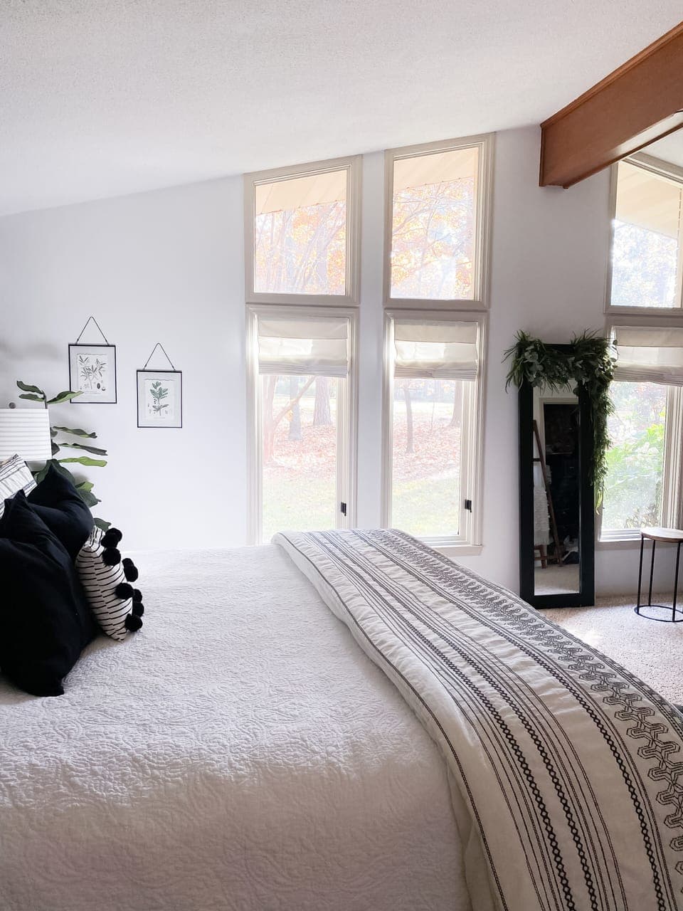 master includes large windows with views of the flower filled yard