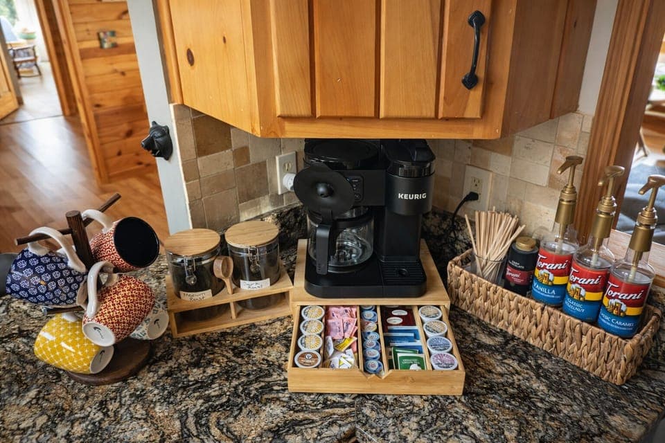 Fully stocked coffee bar with Keurig, syrups, pods, and teas
