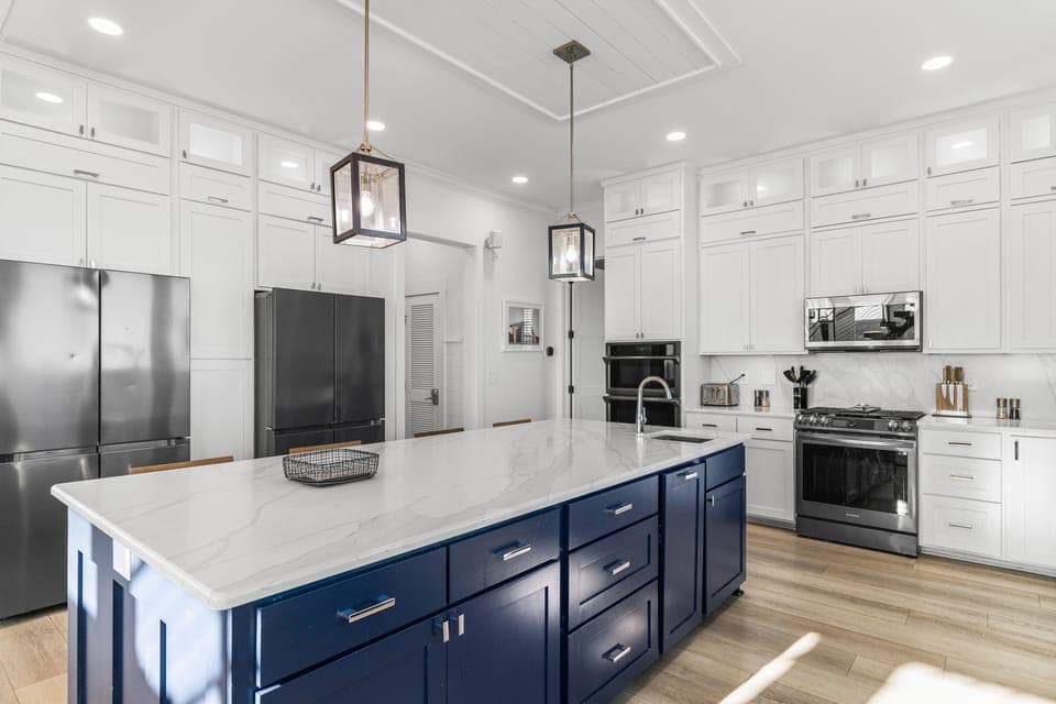 Your culinary haven awaits with spacious marble countertops, premium stainless steel appliances, and elegant pendant lighting perfect for cooking memorable meals together.