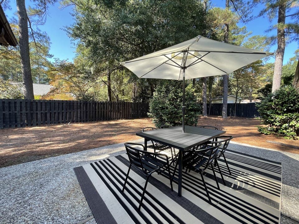Private back yard with seating for six under shade.