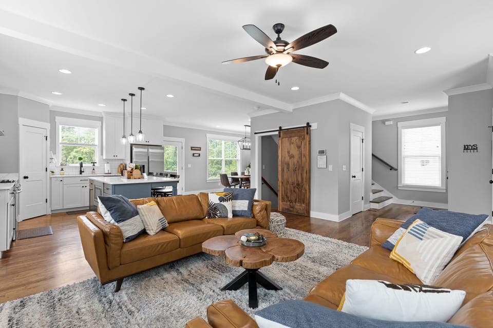 Two large leather sofas, inviting spaces with lots of natural light to relax!