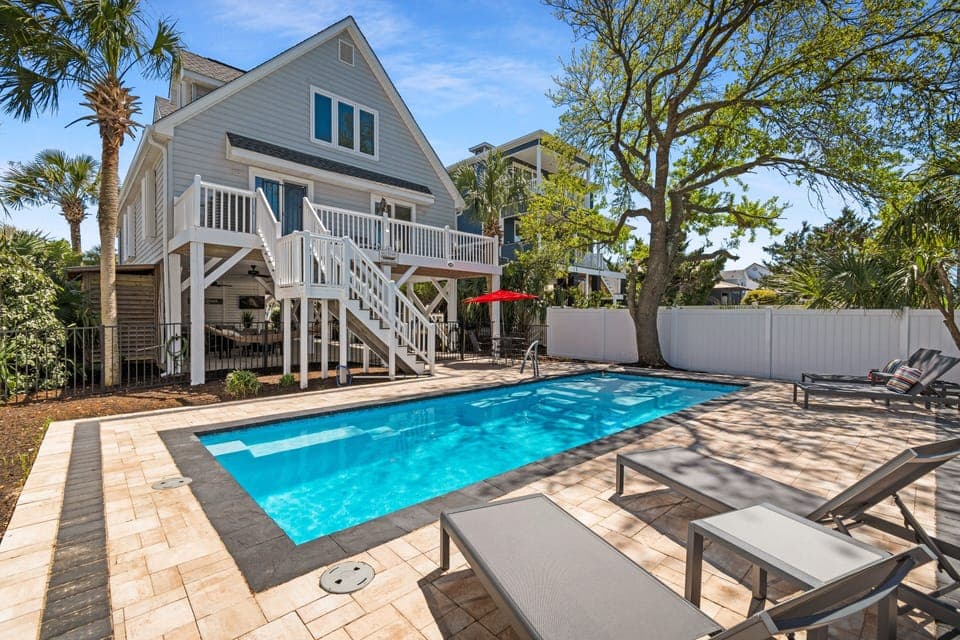 Your private poolside paradise awaits with crystal-clear waters, comfortable loungers, and tropical landscaping creating the perfect Florida retreat.