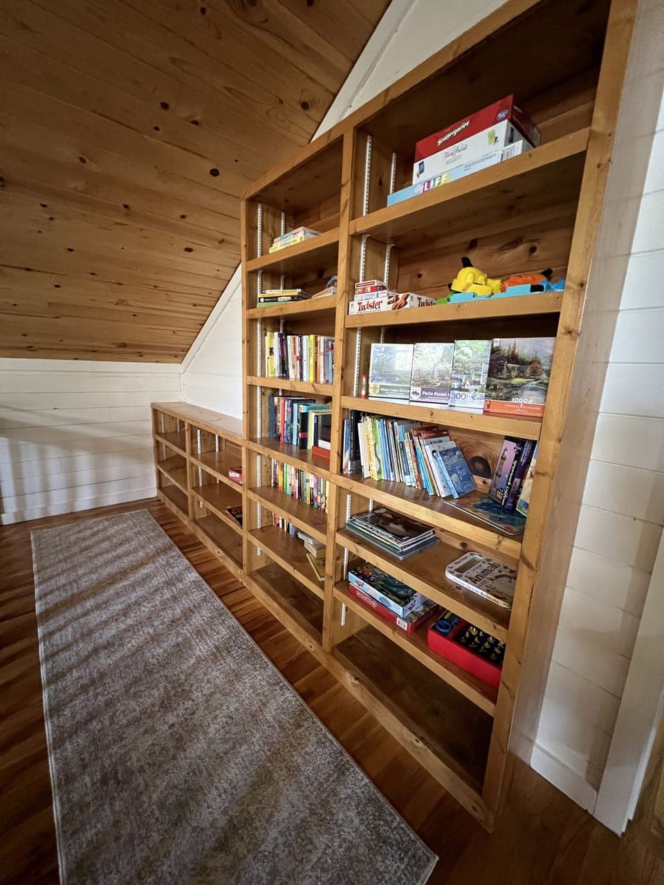 Book Shelves with lots of books, games, and puzzles for all ages