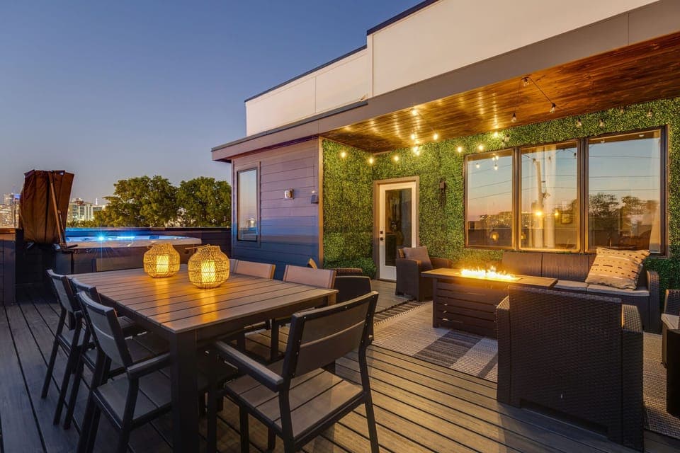 Private rooftop deck with outdoor fire pit, lounge area, dining area, BBQ grill, twinkling bistro lights, and HOT TUB.