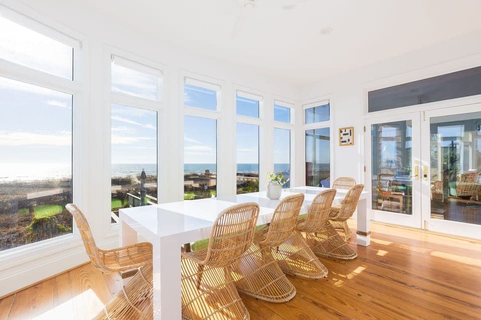 This bright coastal dining space offers panoramic views and unforgettable mealtime moments.
