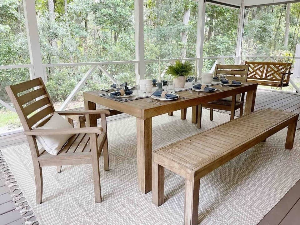 Off the kitchen is a screened-in porch with a large dining table. 
